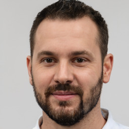 Joyful white adult male with short  brown hair and brown eyes