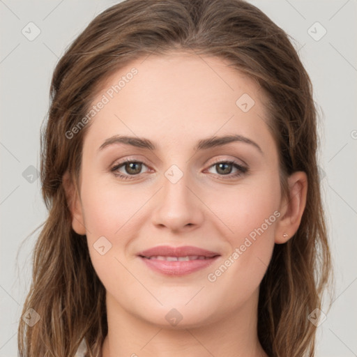 Joyful white young-adult female with long  brown hair and green eyes