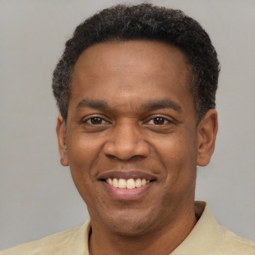 Joyful latino adult male with short  brown hair and brown eyes