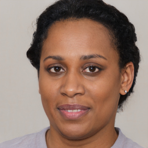Joyful latino young-adult female with short  black hair and brown eyes