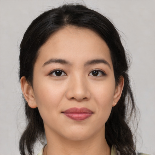 Joyful latino young-adult female with medium  brown hair and brown eyes
