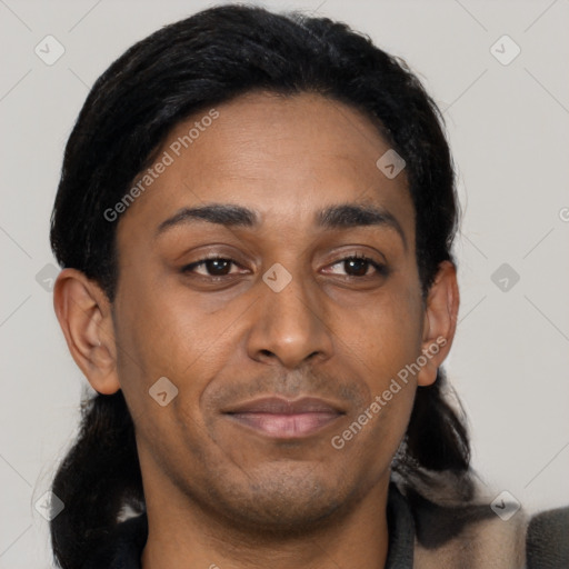 Joyful latino young-adult male with short  brown hair and brown eyes