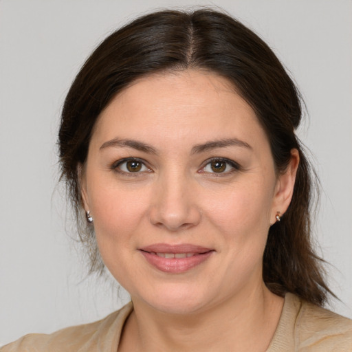 Joyful white young-adult female with medium  brown hair and brown eyes