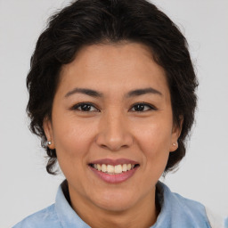 Joyful asian adult female with medium  brown hair and brown eyes