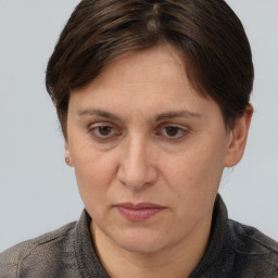 Joyful white adult female with short  brown hair and brown eyes