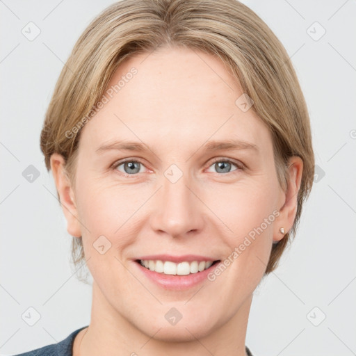 Joyful white young-adult female with short  brown hair and grey eyes