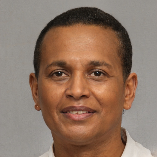 Joyful latino adult male with short  brown hair and brown eyes