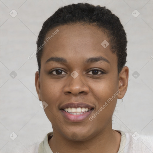 Joyful black young-adult female with short  brown hair and brown eyes