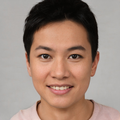 Joyful asian young-adult female with short  brown hair and brown eyes