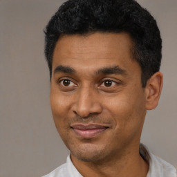 Joyful latino young-adult male with short  black hair and brown eyes