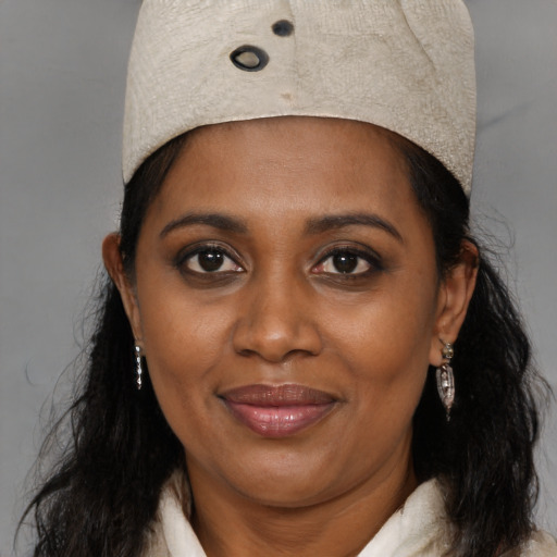 Joyful black young-adult female with medium  brown hair and brown eyes