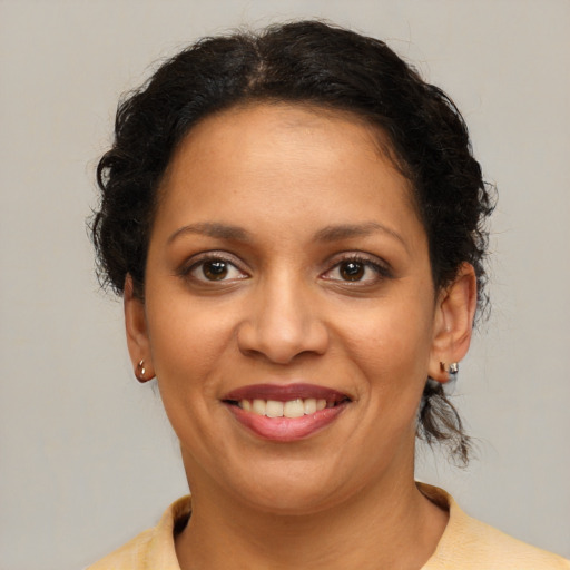 Joyful latino young-adult female with short  brown hair and brown eyes
