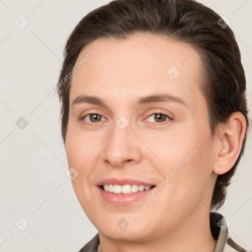 Joyful white young-adult female with short  brown hair and brown eyes