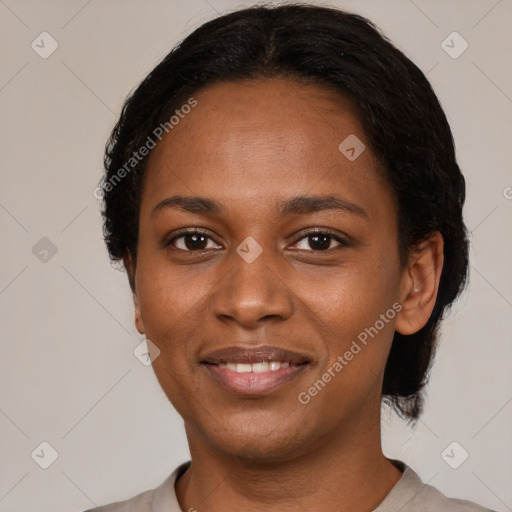 Joyful black young-adult female with short  black hair and brown eyes