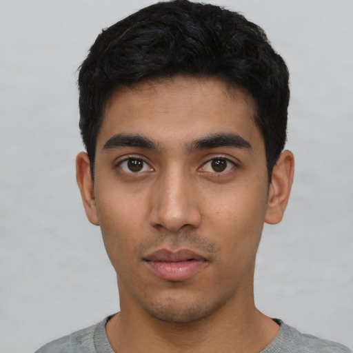 Neutral latino young-adult male with short  black hair and brown eyes