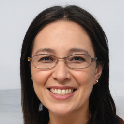 Joyful white adult female with long  brown hair and brown eyes