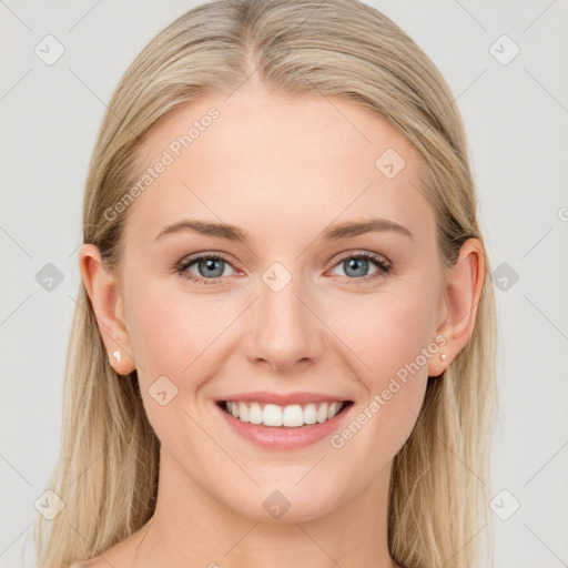 Joyful white young-adult female with long  brown hair and blue eyes