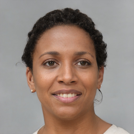 Joyful black young-adult female with short  brown hair and brown eyes