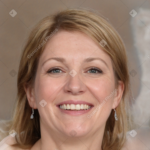 Joyful white adult female with medium  brown hair and blue eyes