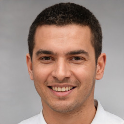 Joyful white young-adult male with short  brown hair and brown eyes