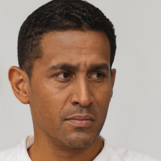 Neutral latino adult male with short  black hair and brown eyes