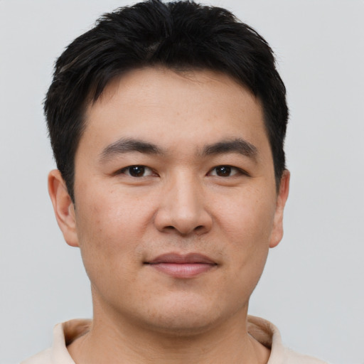 Joyful asian young-adult male with short  brown hair and brown eyes