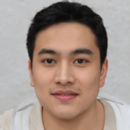 Joyful asian young-adult male with short  black hair and brown eyes