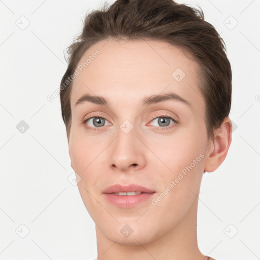 Joyful white young-adult female with short  brown hair and grey eyes