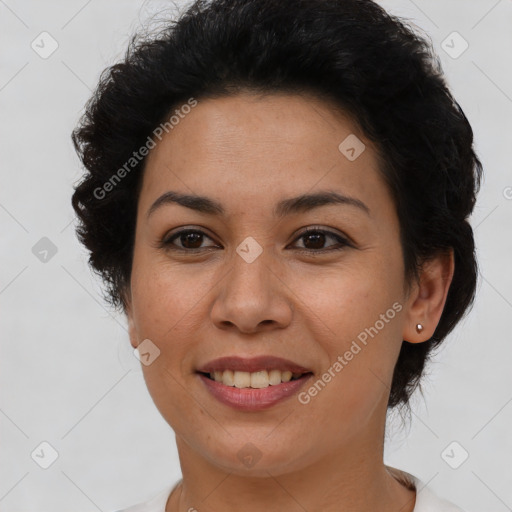 Joyful latino adult female with short  brown hair and brown eyes