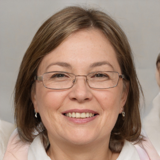 Joyful white adult female with medium  brown hair and blue eyes