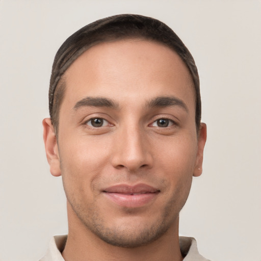 Joyful white young-adult male with short  brown hair and brown eyes