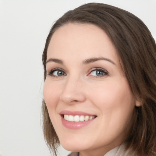 Joyful white young-adult female with long  brown hair and green eyes