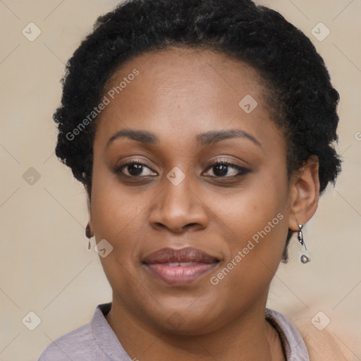 Joyful black young-adult female with short  brown hair and brown eyes