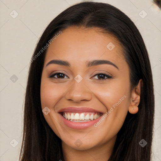 Joyful latino young-adult female with long  brown hair and brown eyes