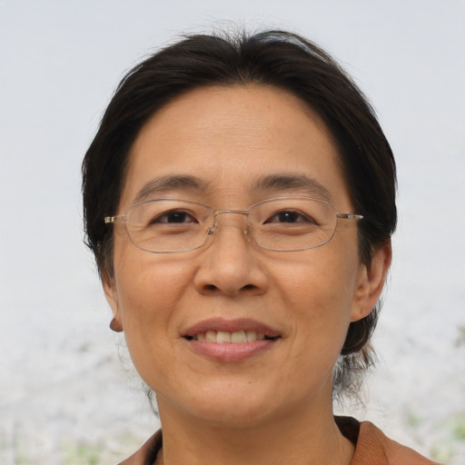 Joyful asian adult female with medium  brown hair and brown eyes