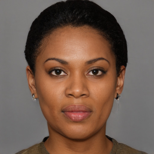 Joyful black young-adult female with short  brown hair and brown eyes