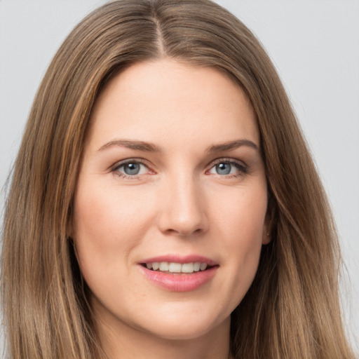 Joyful white young-adult female with long  brown hair and grey eyes