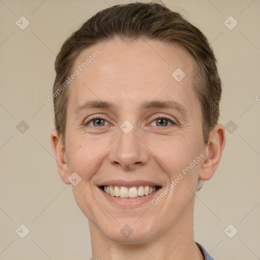 Joyful white adult male with short  brown hair and grey eyes