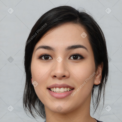 Joyful asian young-adult female with medium  black hair and brown eyes