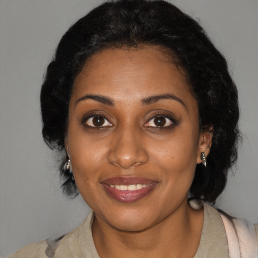 Joyful black young-adult female with medium  black hair and brown eyes