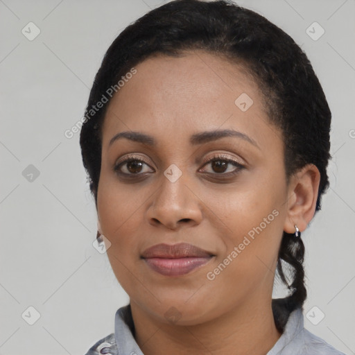 Joyful black young-adult female with short  black hair and brown eyes