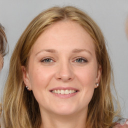 Joyful white young-adult female with medium  brown hair and blue eyes