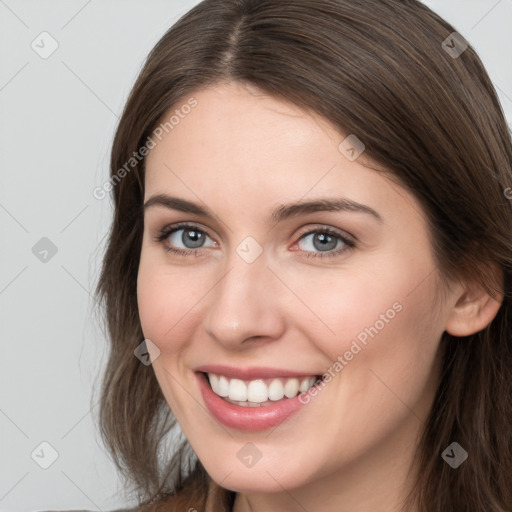 Joyful white young-adult female with long  brown hair and grey eyes