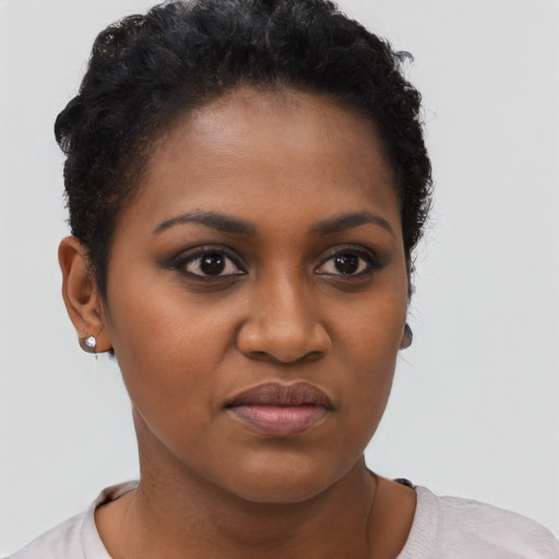 Joyful black young-adult female with short  brown hair and brown eyes