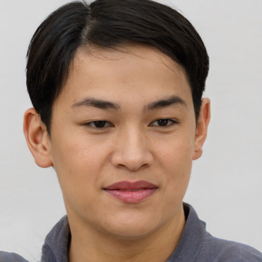 Joyful asian young-adult male with short  brown hair and brown eyes