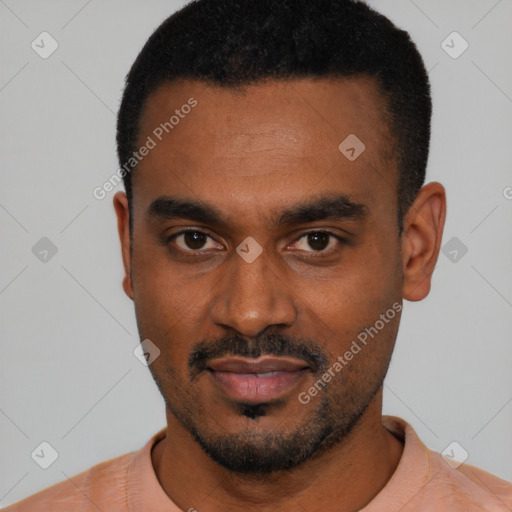 Joyful black young-adult male with short  black hair and brown eyes