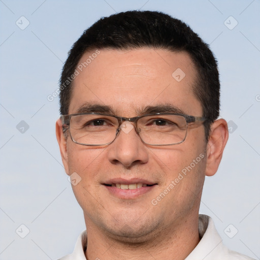 Joyful white adult male with short  black hair and brown eyes