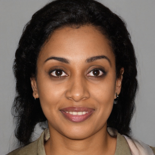 Joyful black young-adult female with medium  black hair and brown eyes