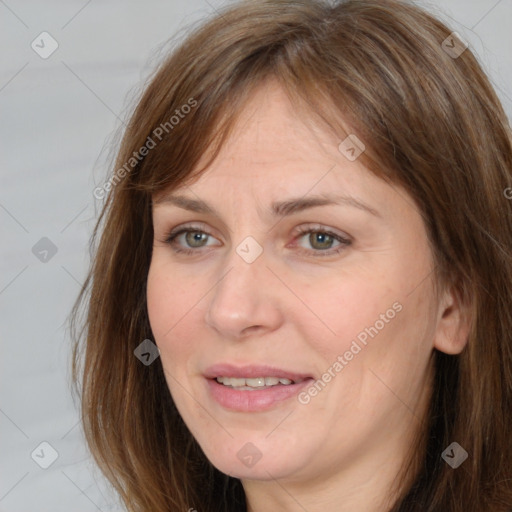 Joyful white adult female with medium  brown hair and brown eyes