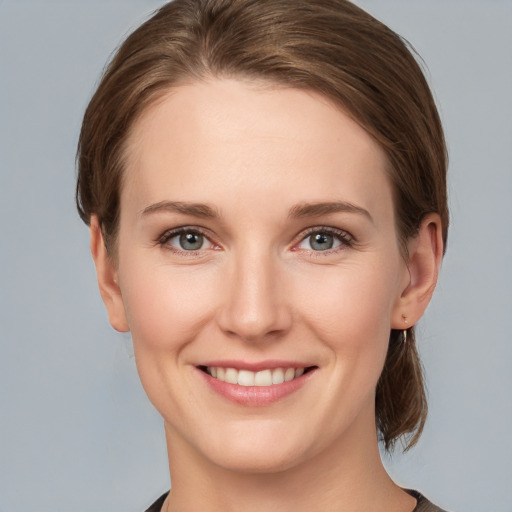 Joyful white young-adult female with short  brown hair and grey eyes